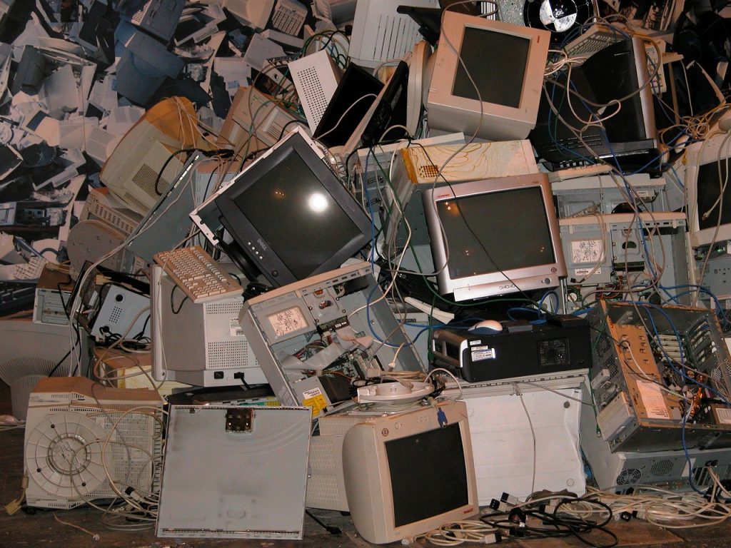 Assorted old electronics collected for recycling at home