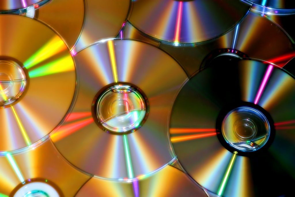 A collection of CDs and DVDs set aside for recycling
